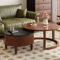 Delvaux round coffee table in a seating group beside a sofa