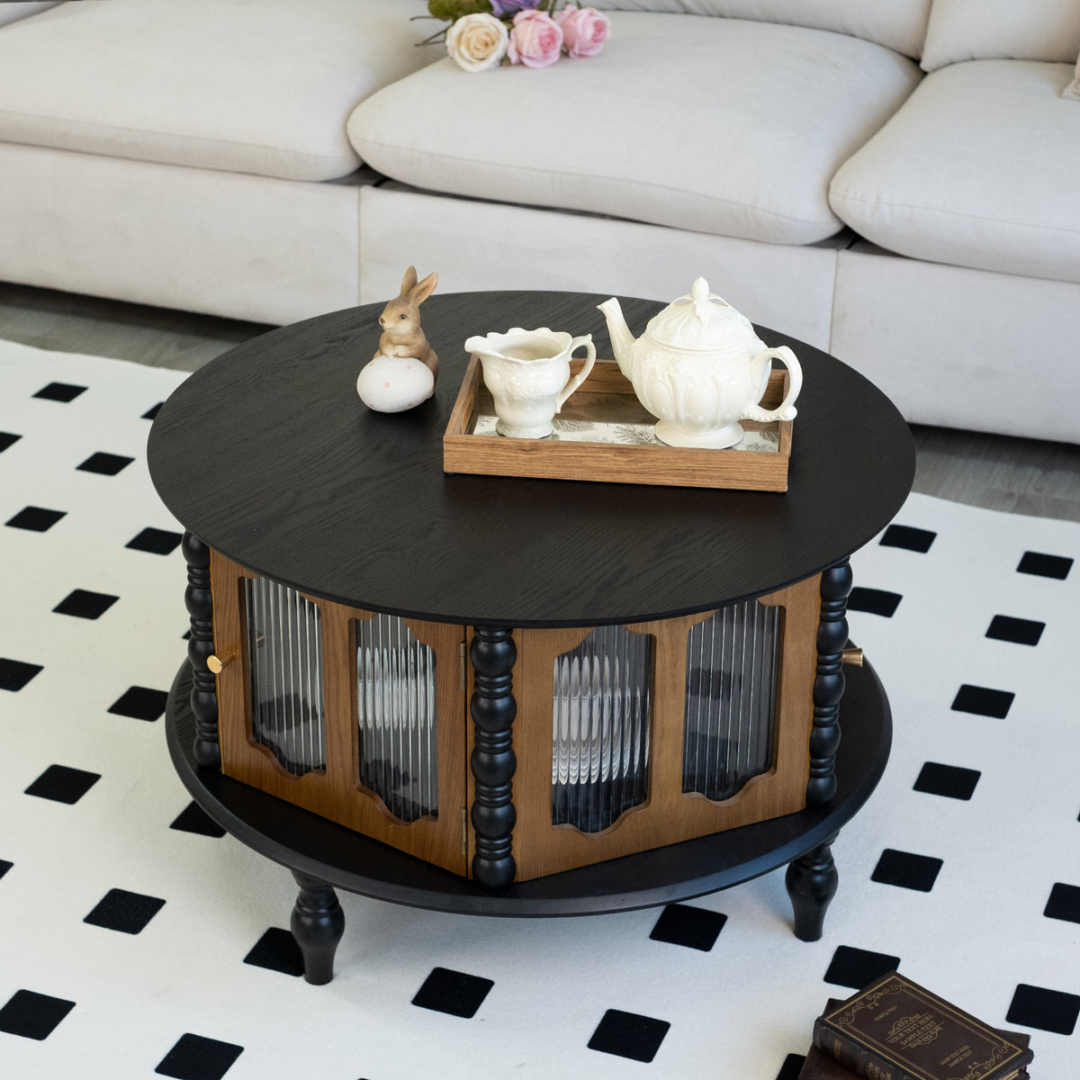 Tarn round storage coffee table in black, in a living room