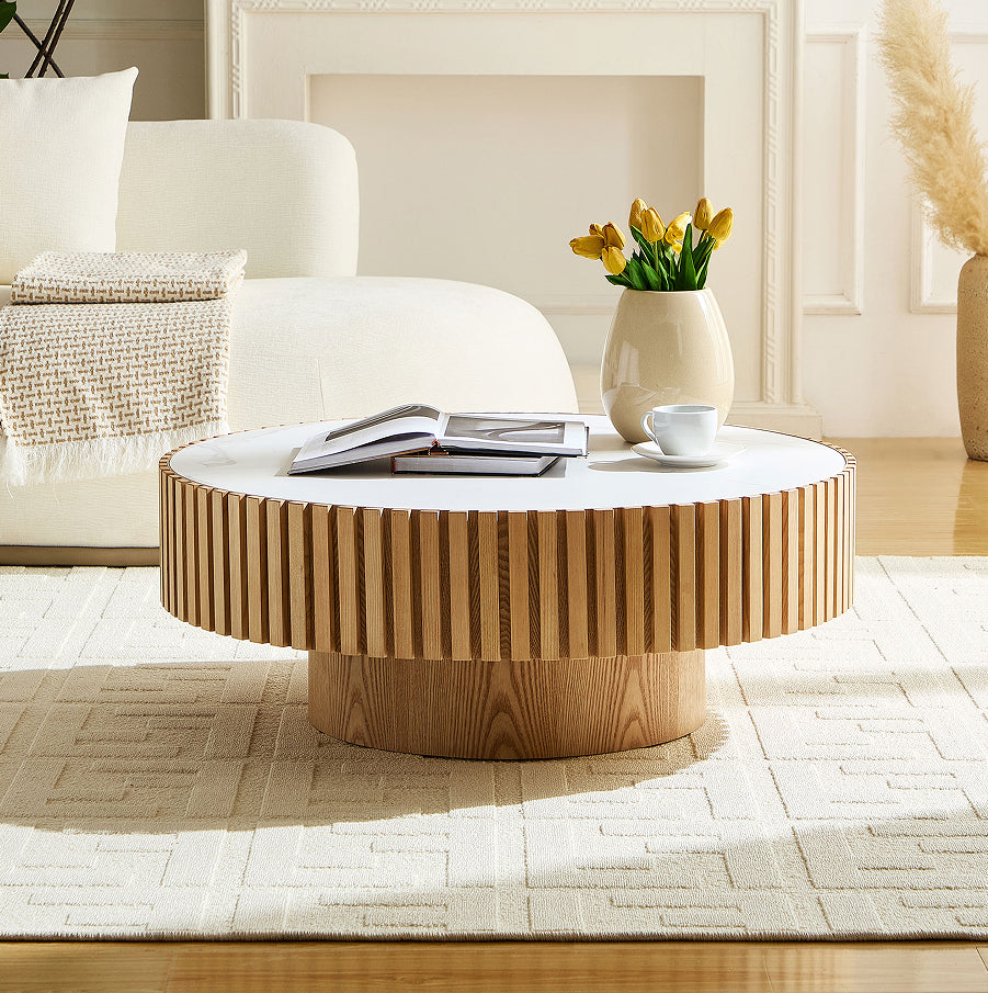 Harlow sintered stone coffee table on a drum base, in a living room