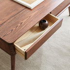 Nyborg storage coffee table in natural wood beside a sofa