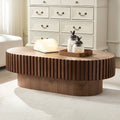 Fjord drum coffee table in walnut, in a living room