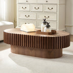 Fjord drum coffee table in walnut, in a living room