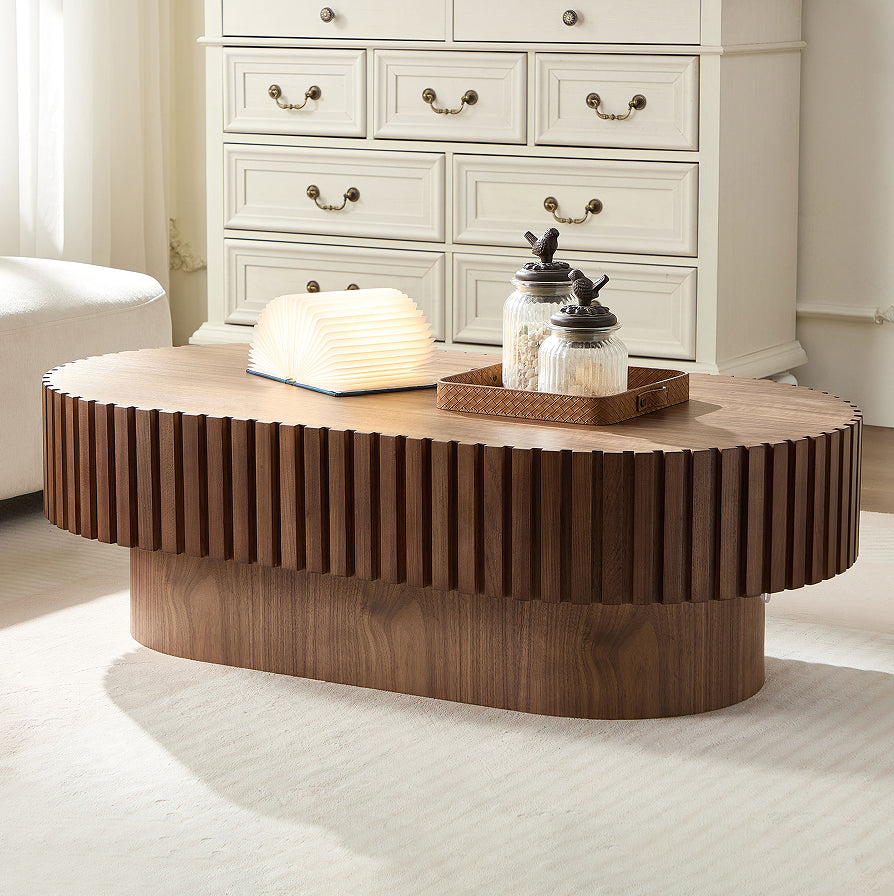 Fjord drum coffee table in walnut, in a living room