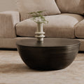 Corniche round metal coffee table in brushed silver, in a living room
