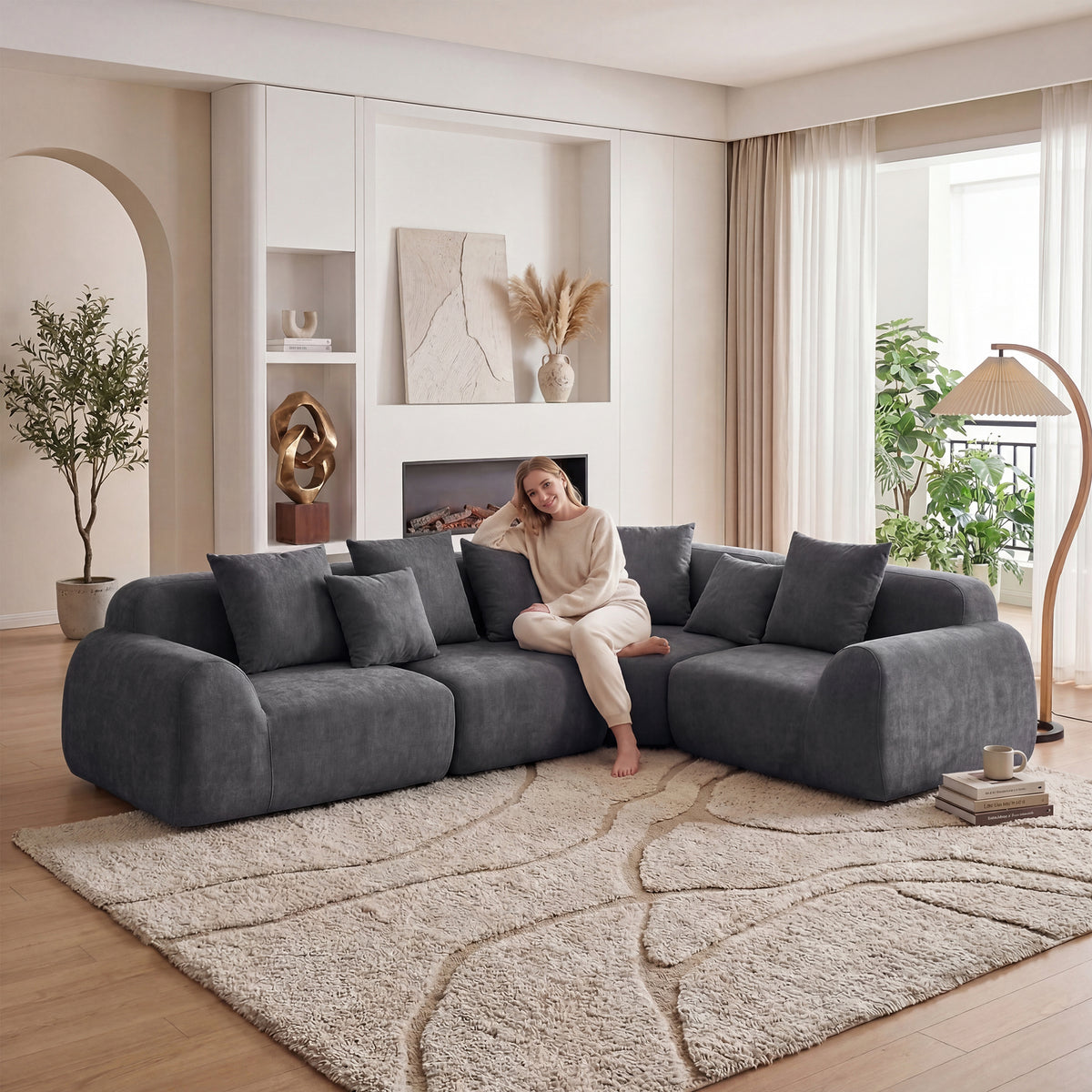 Greve curved sectional in grey, in a living room